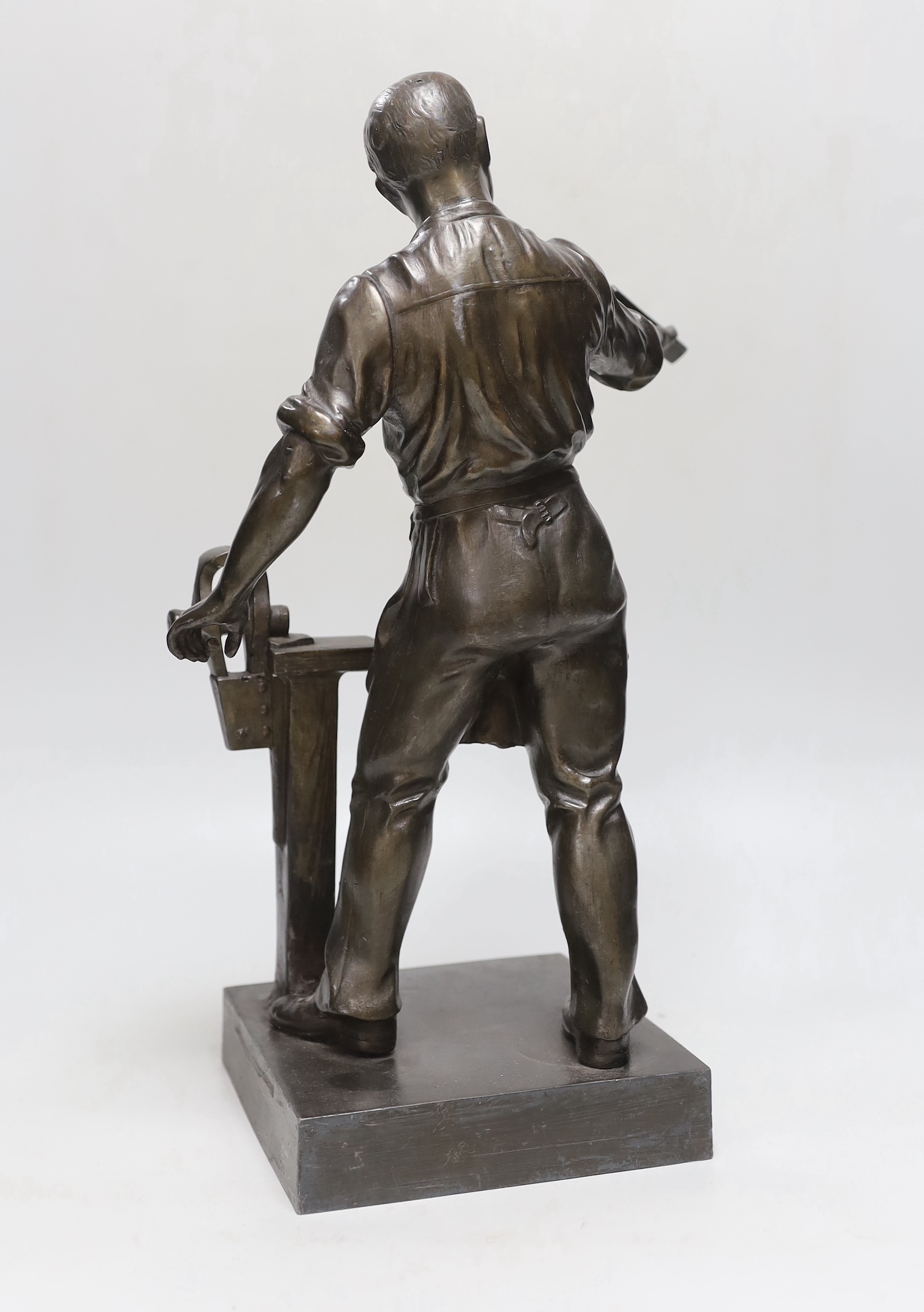 After Metier. A spelter figure of a workman, 40cm high